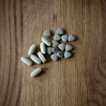 From above of set of different assorted medical pills arranged on lumber surface